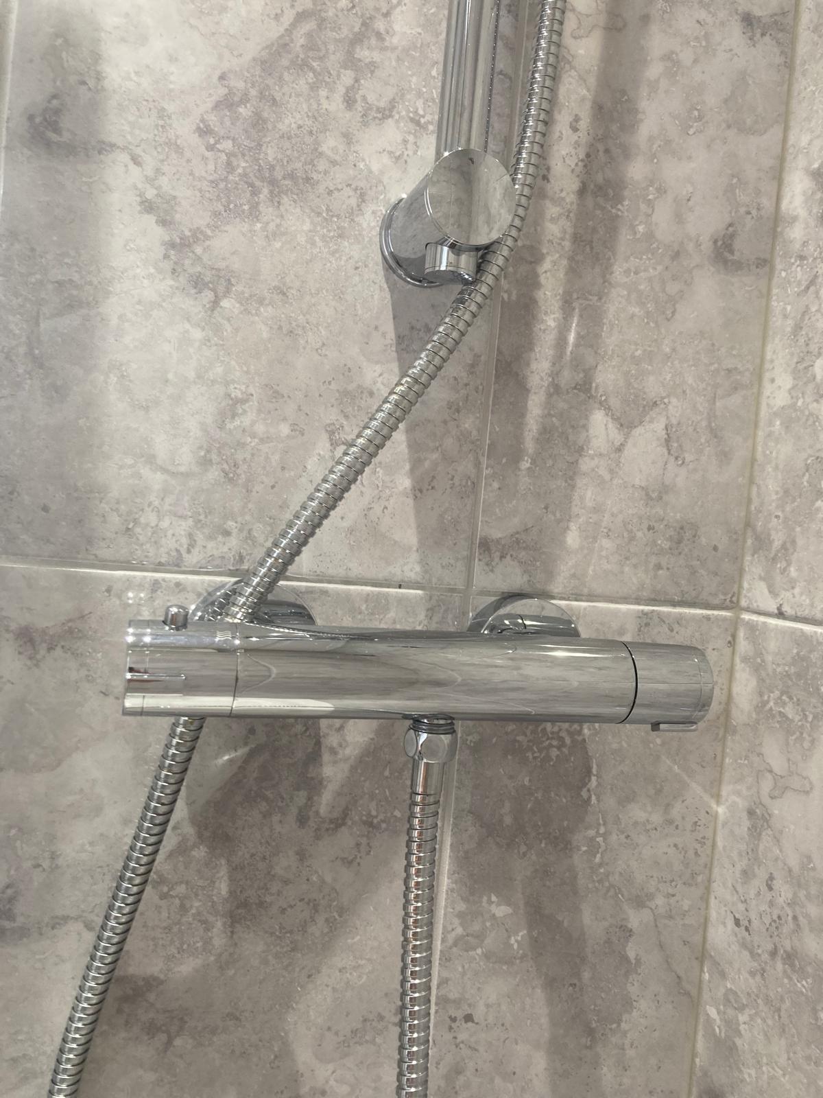 Polished bathroom sink and chrome taps after cleaning